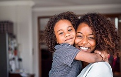 Smiling mother holding daughter