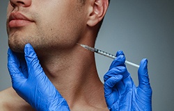 person receiving a BOTOX injection at their jawline