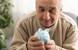 Man holding a blue piggy bank