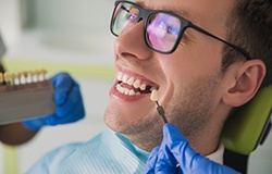 a person sitting in a dental chair with a missing tooth