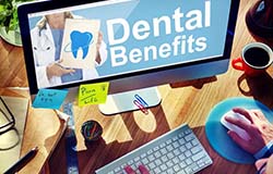 Person exploring dental benefits using a computer
