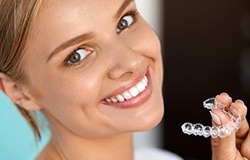 Woman placing Invisalign tray