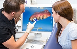 Dentist and patient looking at digital impressions