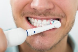 man brushing teeth