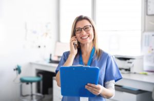 dental staff member confirming patient’s dental checkup over the phone