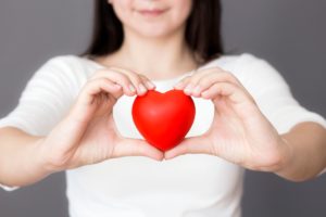 woman holding a red love heart in her hands 