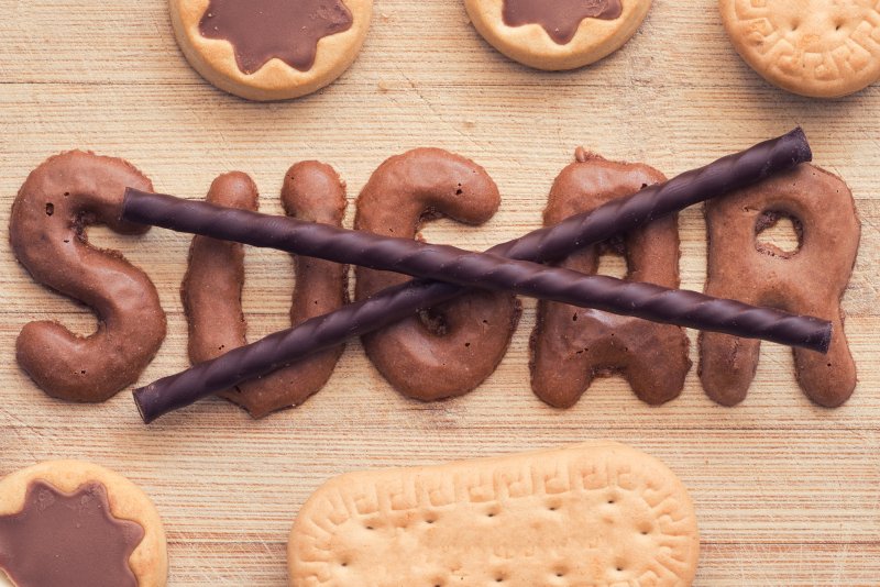 cookies spelling out “sugar” with a chocolate “X” over them