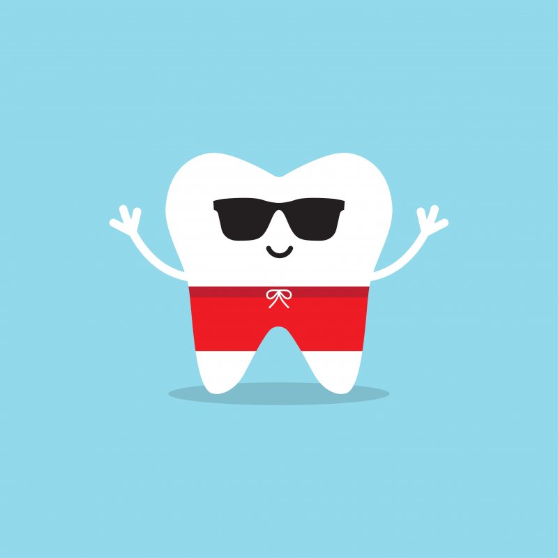 Happy cartoon tooth in sunglasses.
