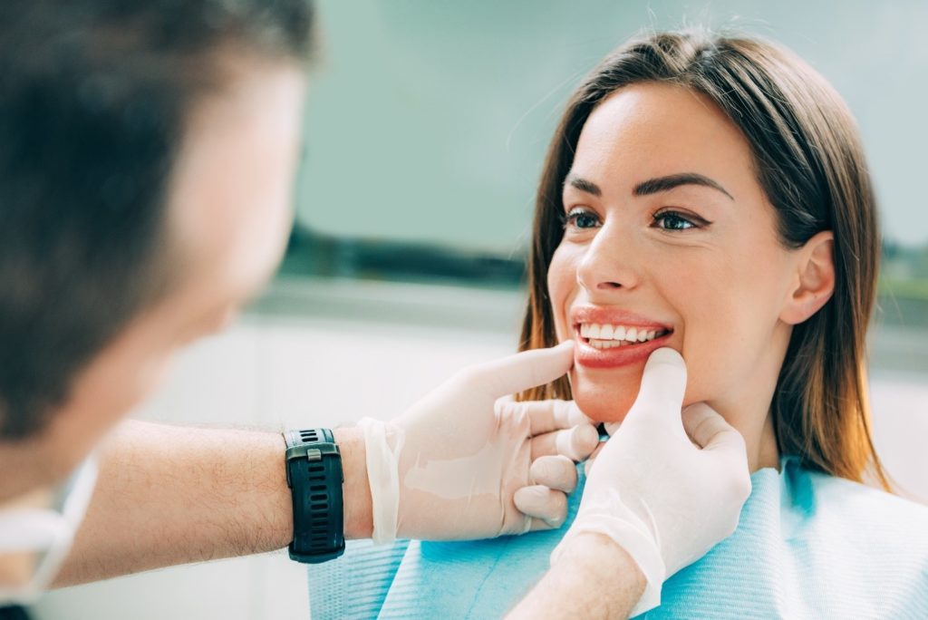 Woman smiling during dental checkup.