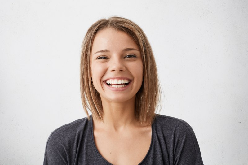 person who had yellow teeth whitened smiling