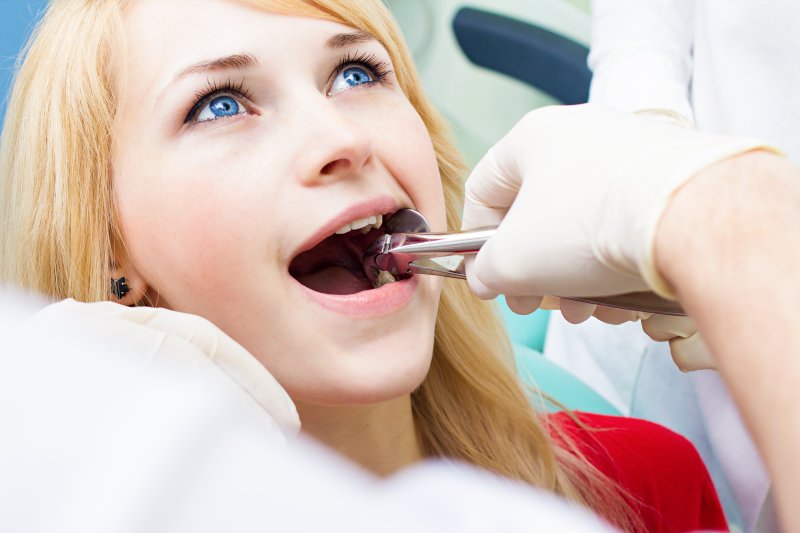 A dentist performing tooth extractions in Orange Park