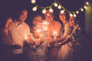 Family holding sparklers to celebrate New Year’s