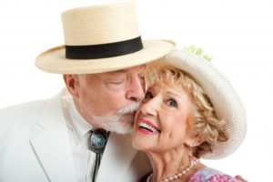 two older people kissing while on a date