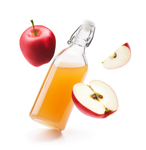 Bottle of apple cider vinegar with fresh apples