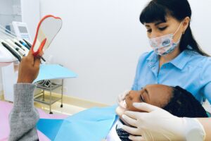 Female dentist examining patient